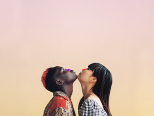 Two people with dark and light skin colors looking up into the sky as their chins touch. Purple and red sunscreen applied to the nose with an ombre effect background
